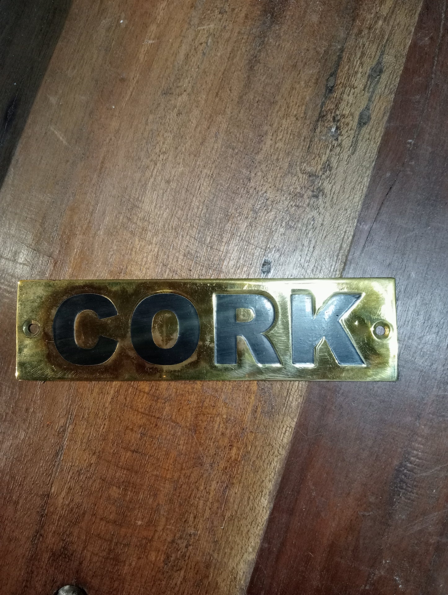 Cork brass sign