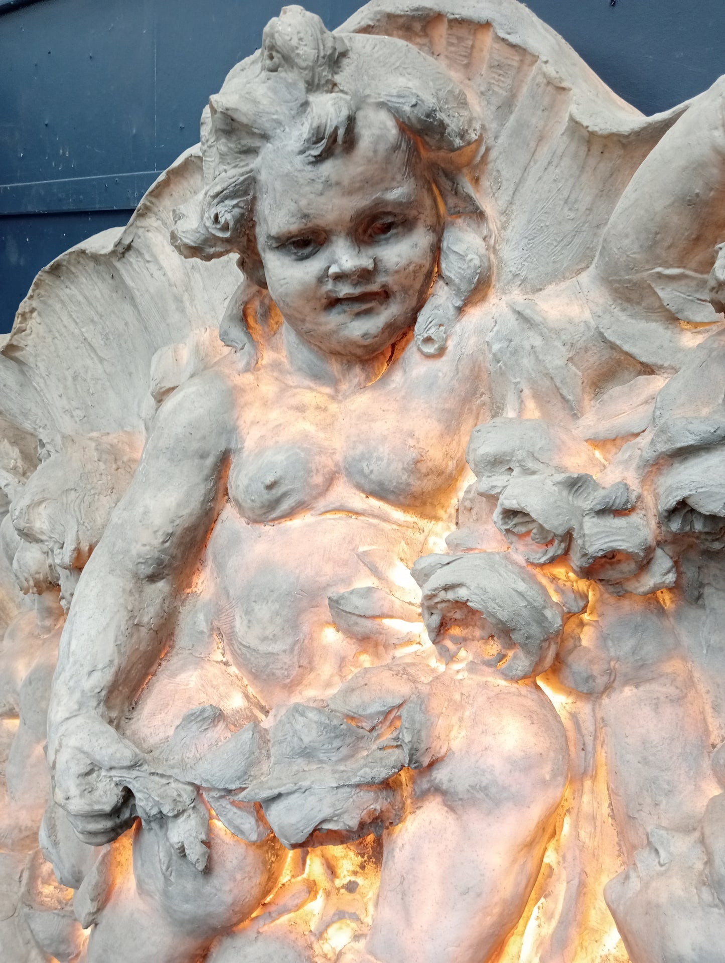 Fiberglass ornate wall mounted plaque depicting musical cherubs