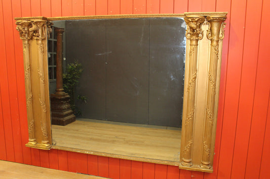 Giltwood overmantle flanked by four pillars surmounted with eagles