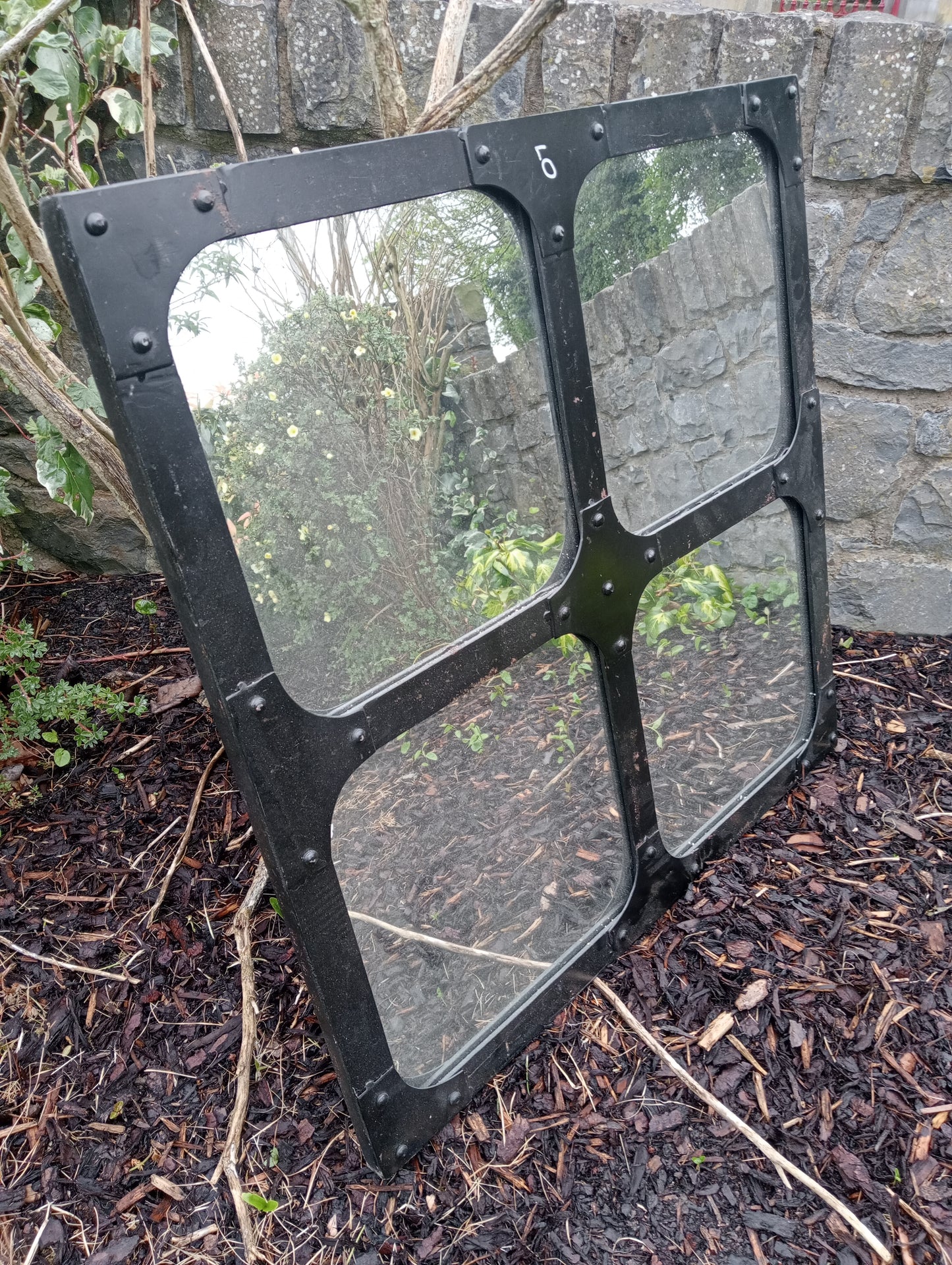 Heavy metal window with four mirrored panels