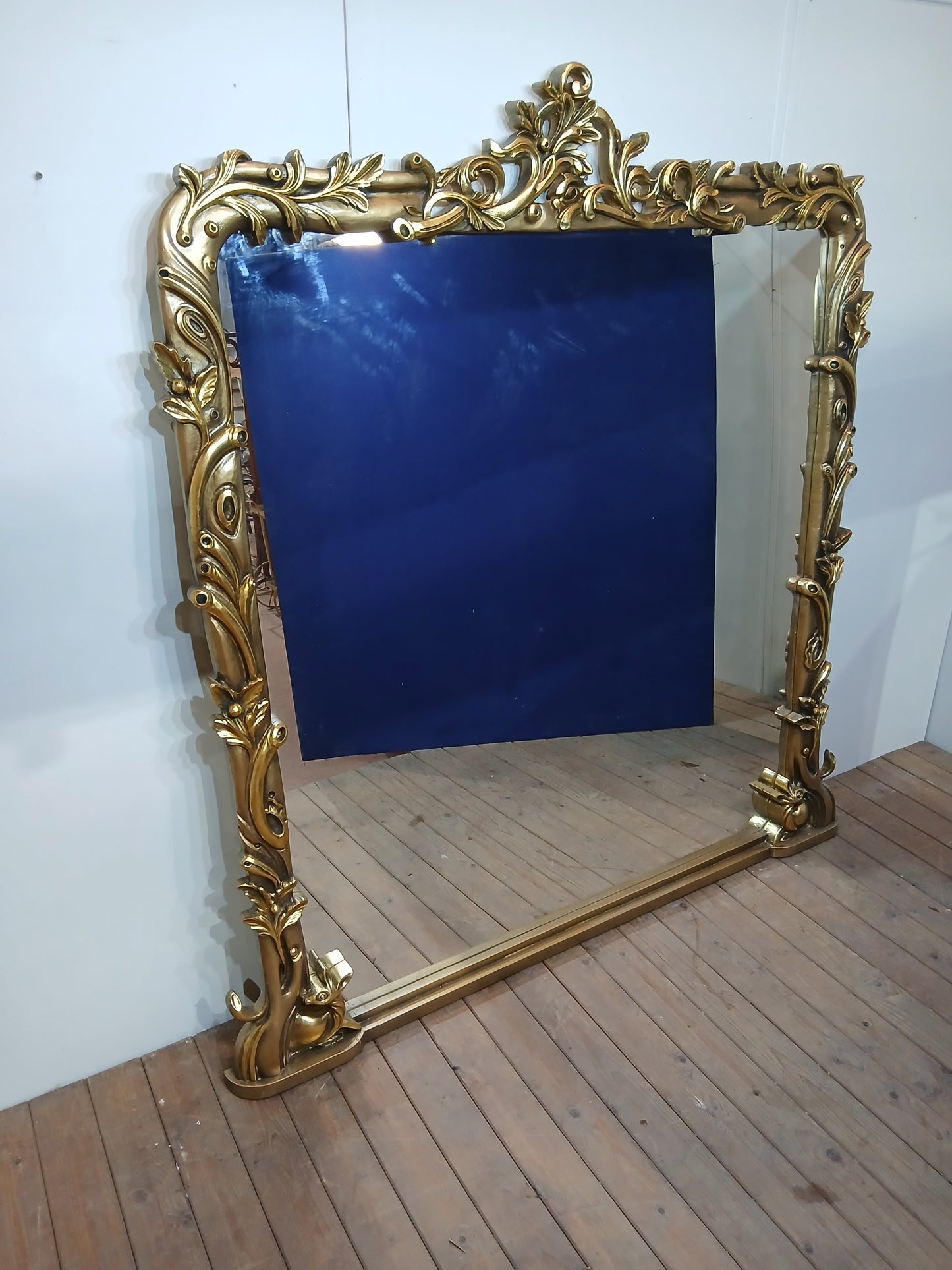 Large giltwood baroque style mirror with deer motif overmantle