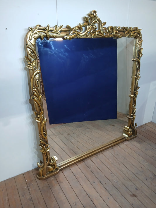 Large giltwood baroque style mirror with deer motif overmantle