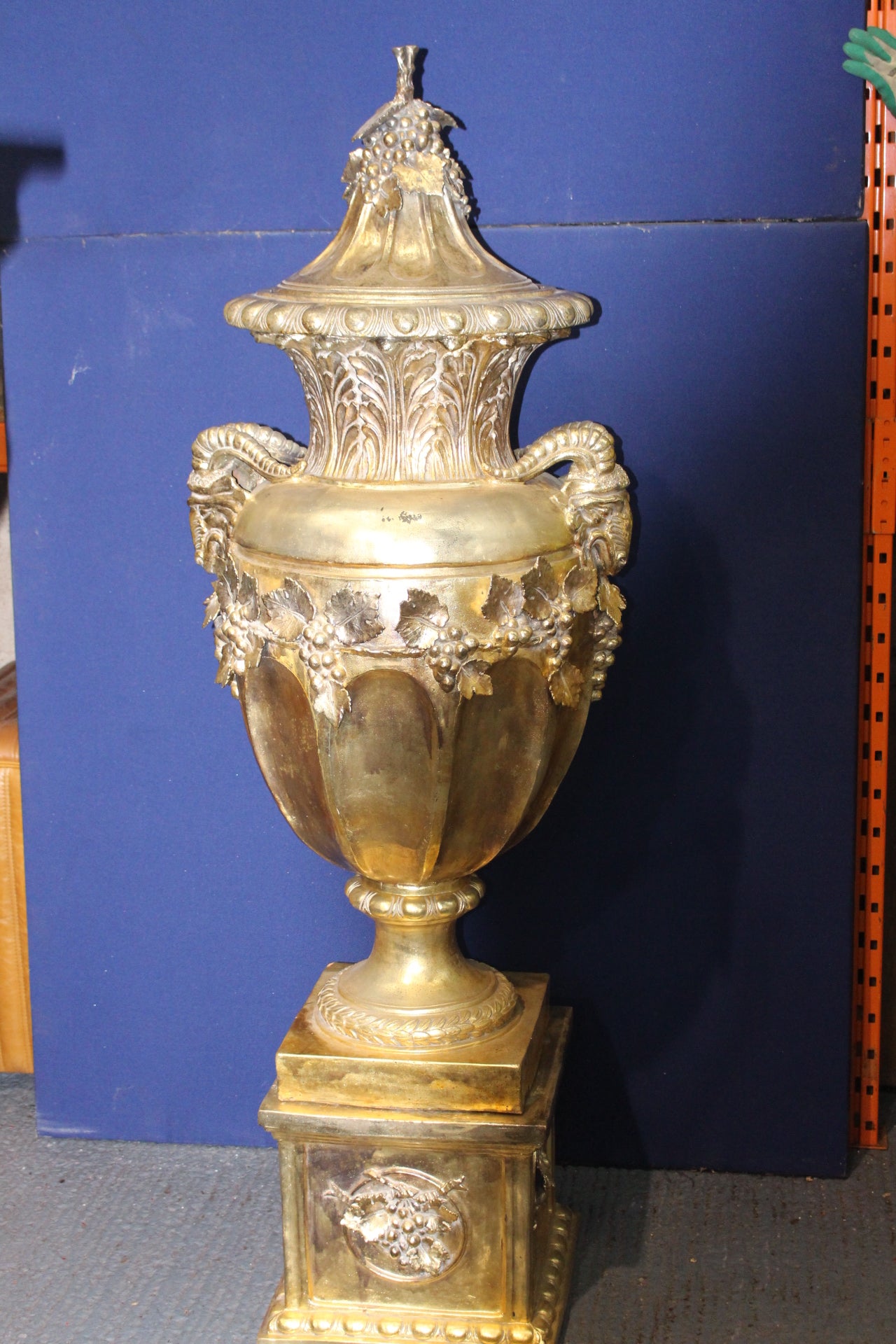 Large ramshead gold guilt urn on stand