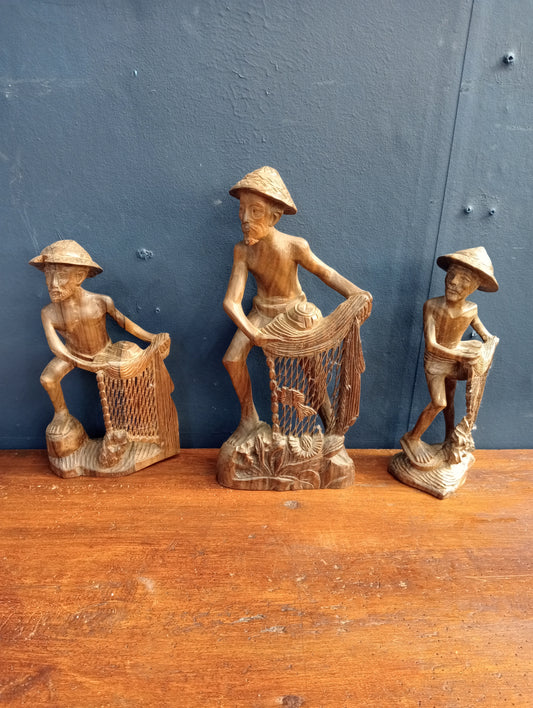 Lot of three balinese hand carved figures of fishermen with nets