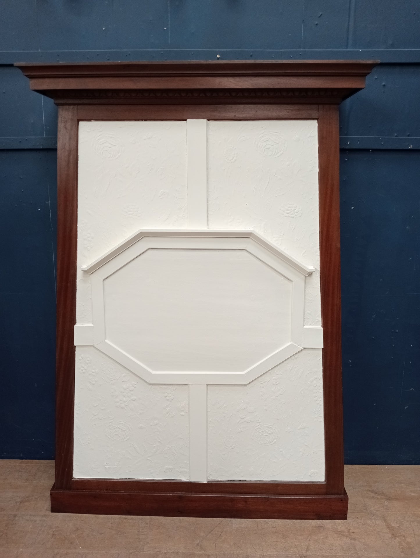 Mahogany mantle with embossed wall paper