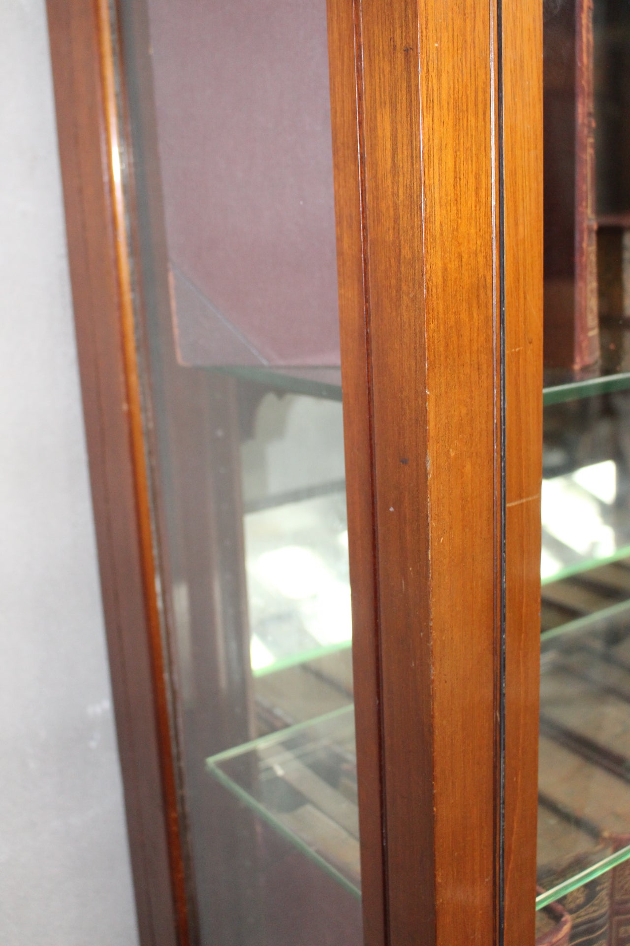 Mahogany shop display cabinet with two glazed doors over four short drawers raised on plinth base