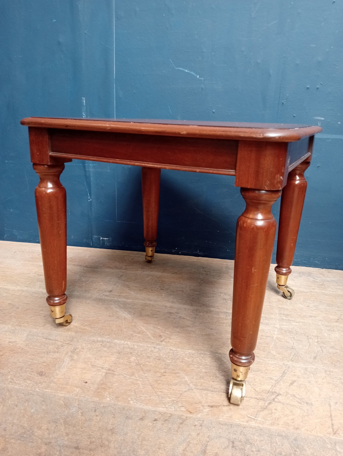 Mahogany table on brass castors