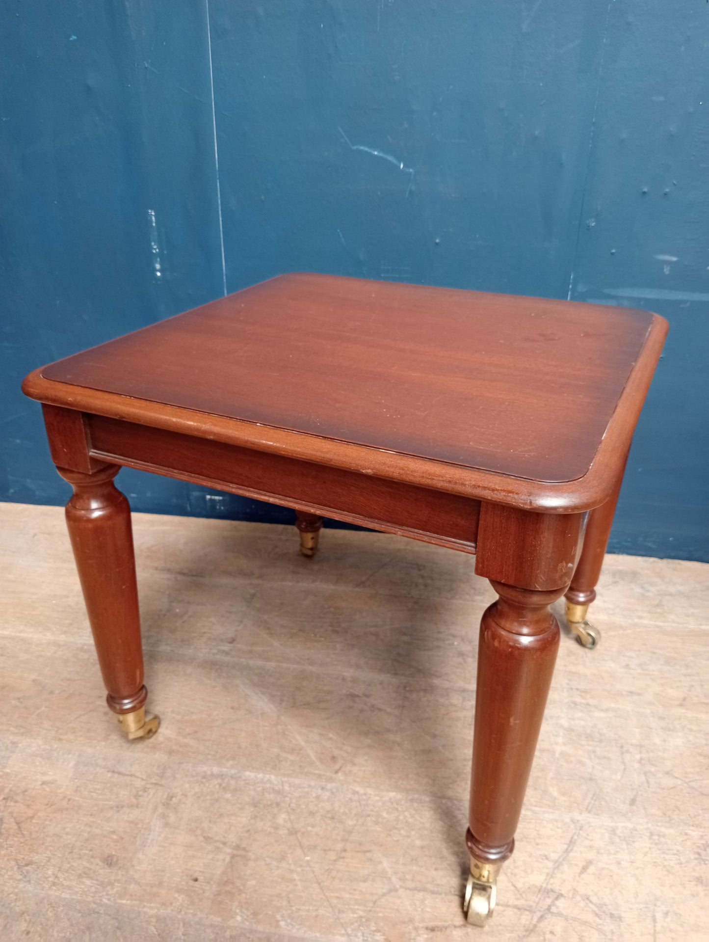 Mahogany table on brass castors