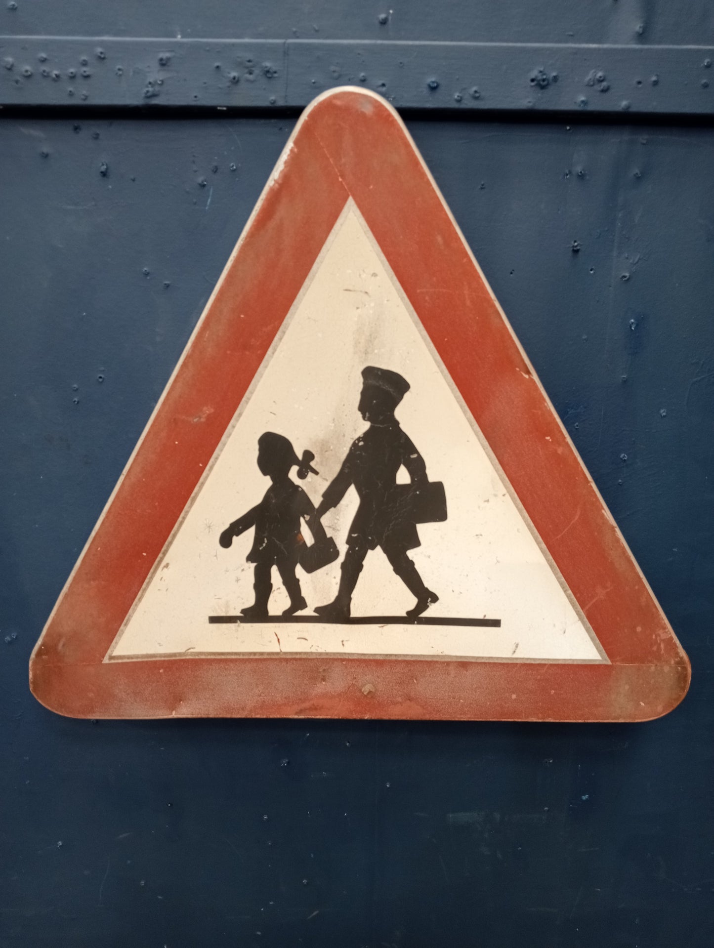 Metal school crossing road sign