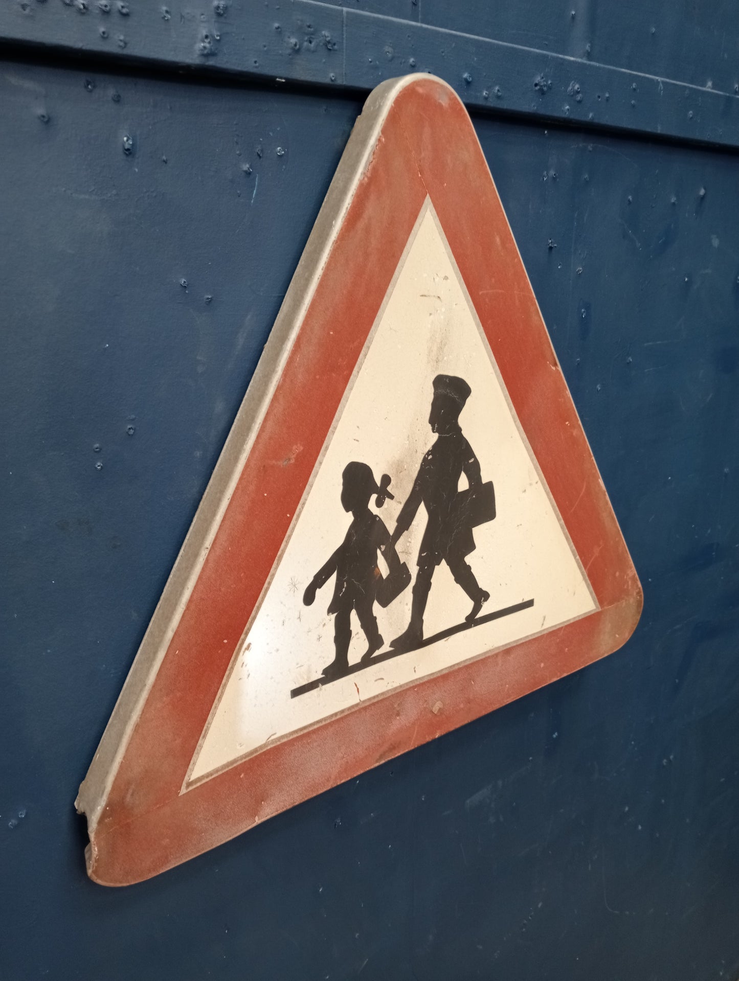 Metal school crossing road sign