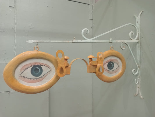 Metal opticians advertising sign on metal bracket