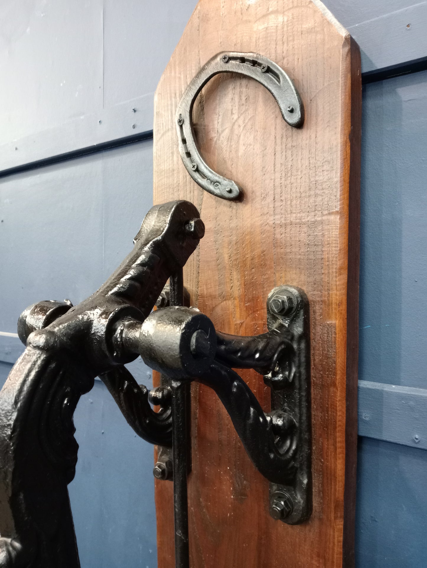 Ornate cast iron pump on wooden board