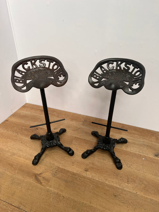 Pair of Cast Iron Blackstone tractor  High swivel stool