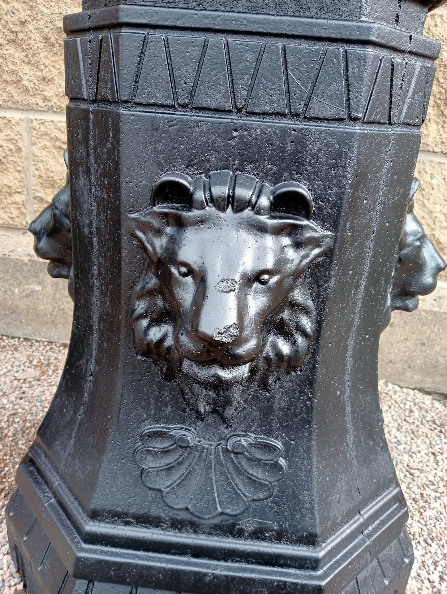 Pair of Cast iron urns on stone base with lions head decoration