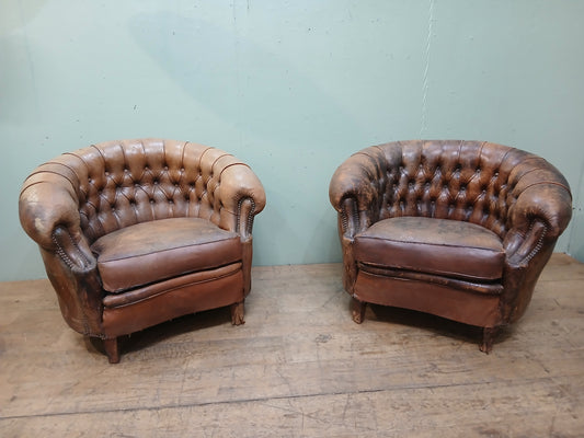 Pair of Italian distressed club chairs deep button