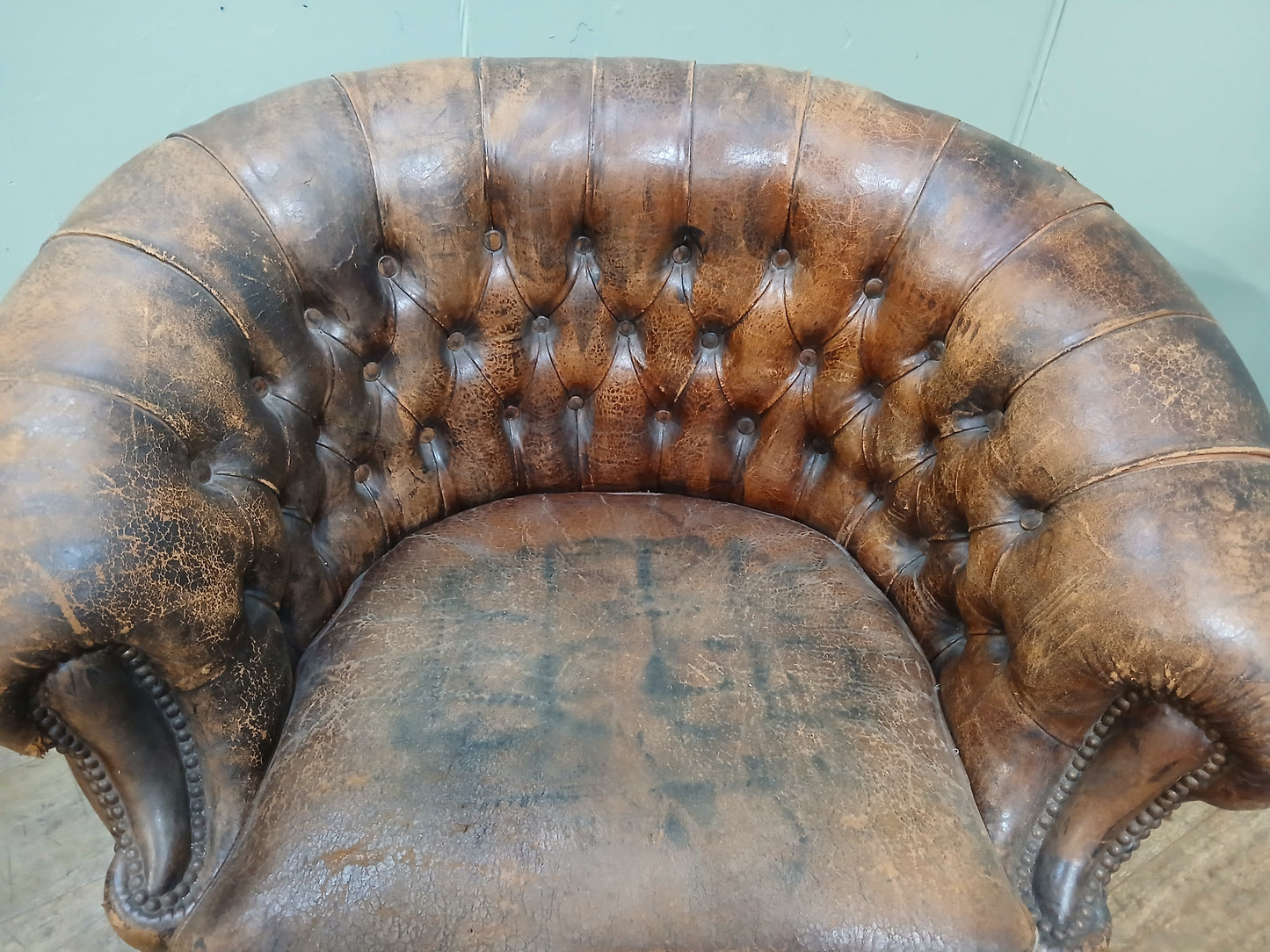 Pair of Italian distressed club chairs deep button