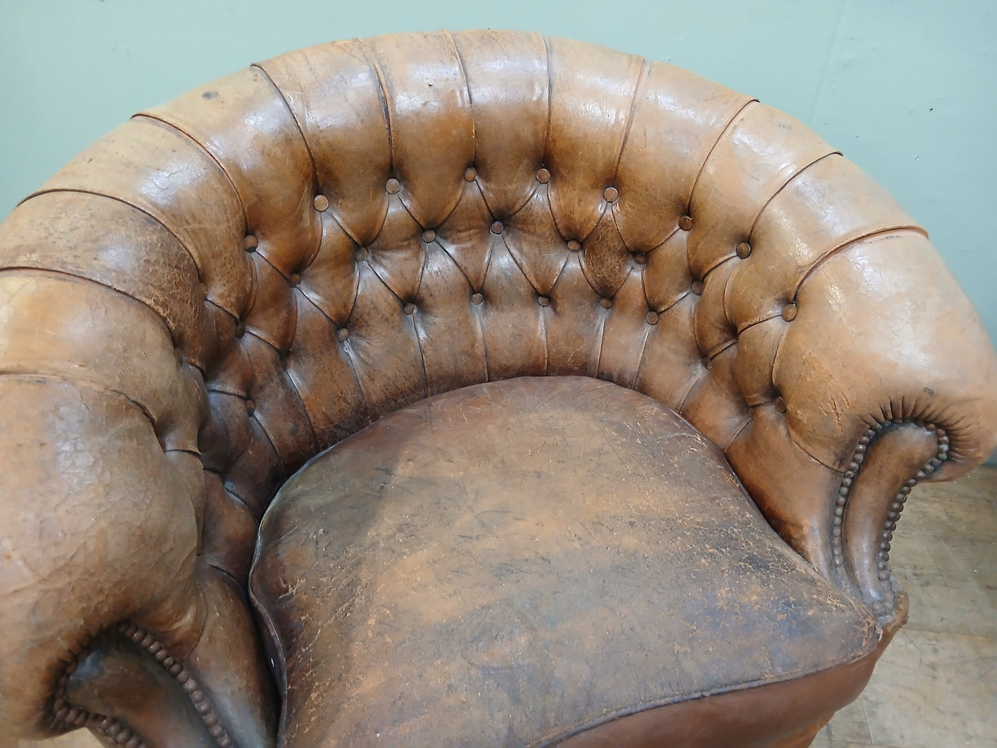 Pair of Italian distressed club chairs deep button