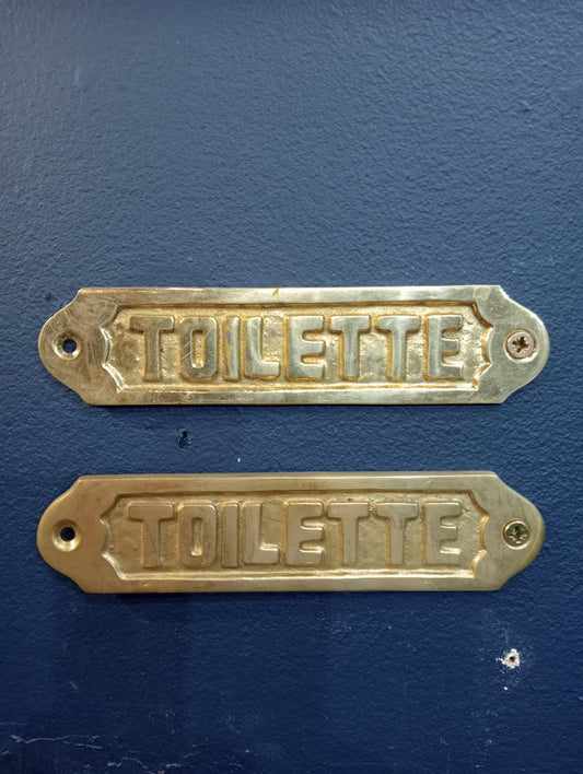 Pair of brass toilette signs