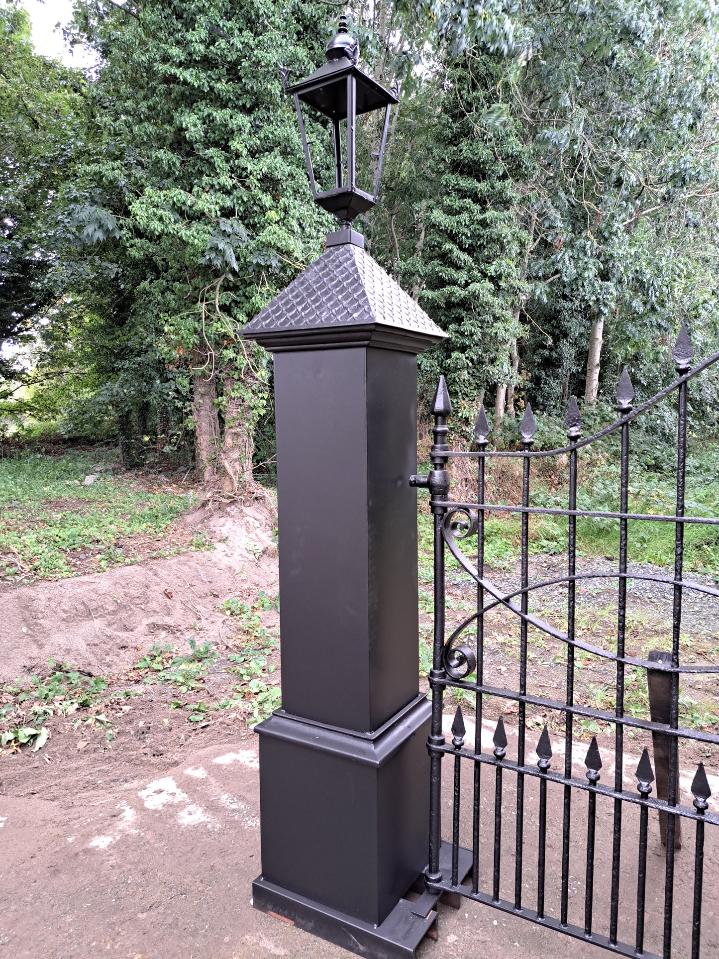 Pair of cast-steel posts with Georgian cast iron scroll gates with pointed finials