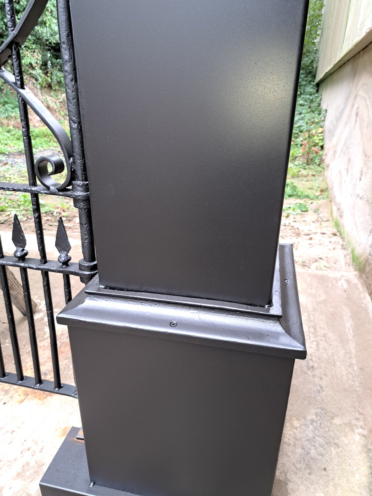 Pair of cast-steel posts with Georgian cast iron scroll gates with pointed finials