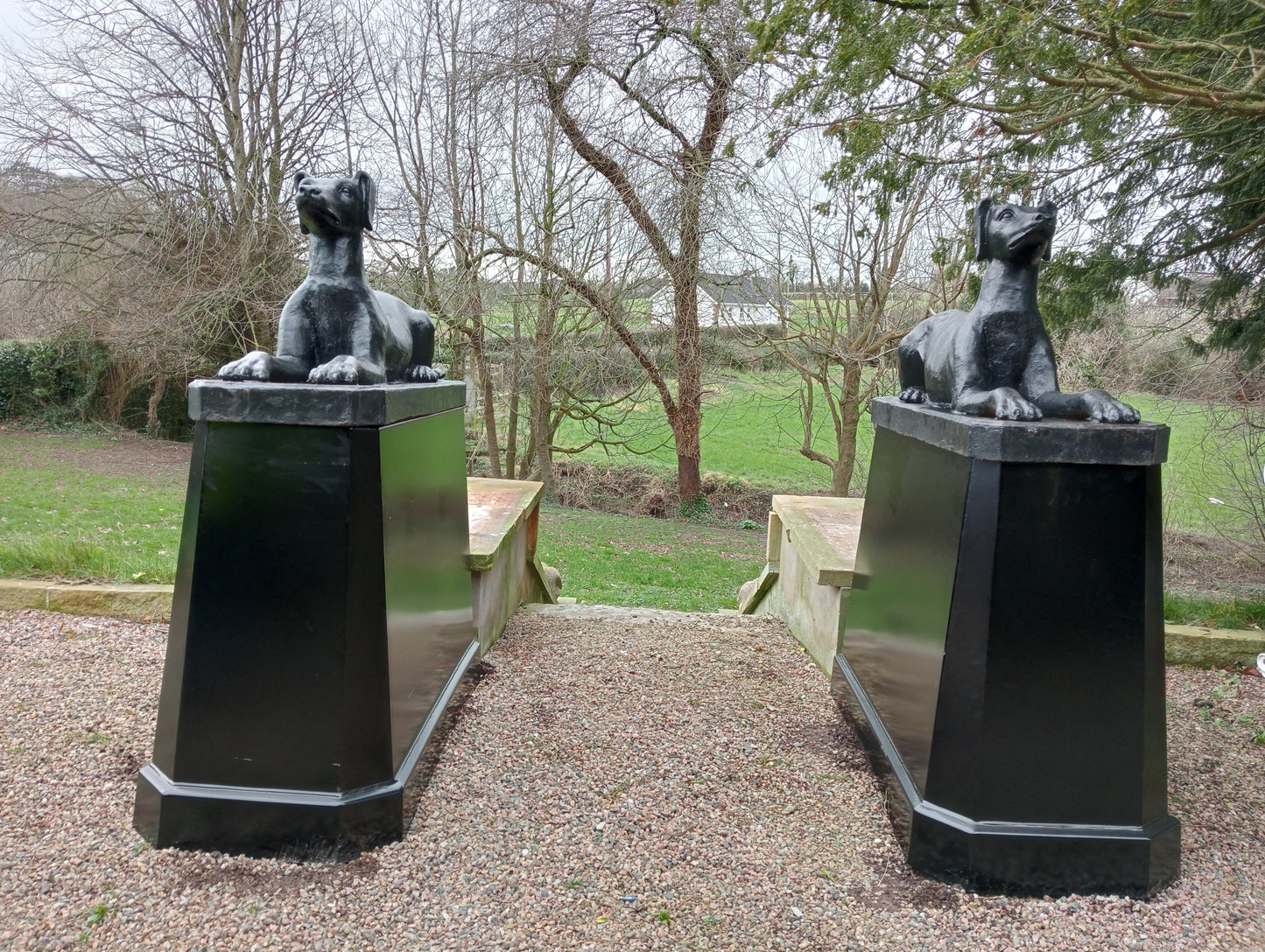 Pair of cast iron dogs and bases