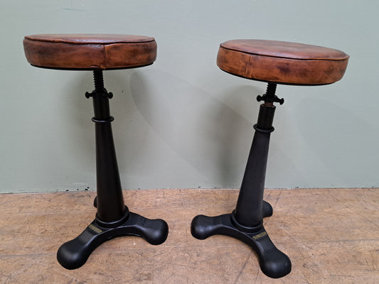 Pair of cast iron singer swivel stools with leather seats -Rise and fall