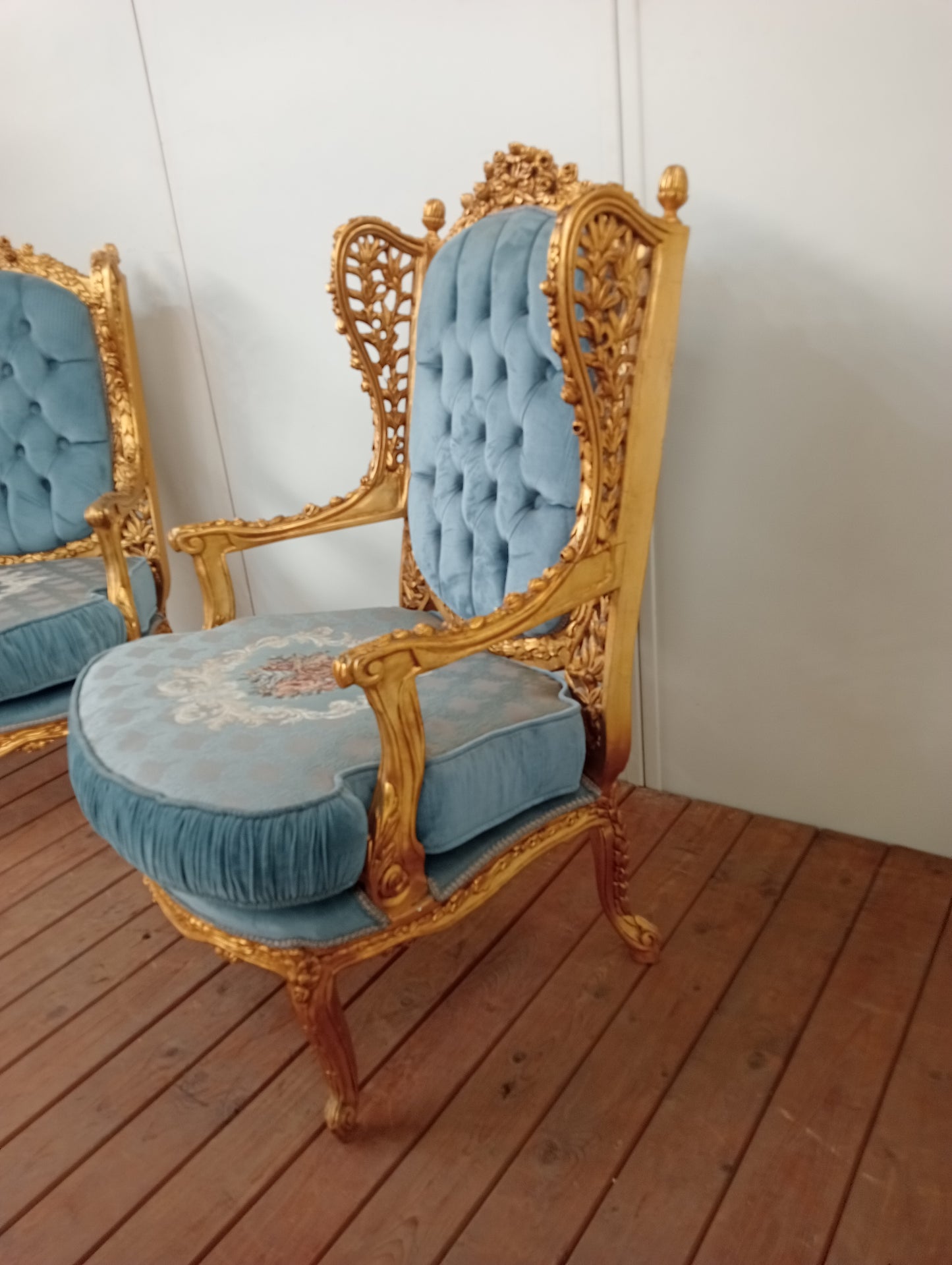 Pair of giltwood French style armchairs deep button floral design blue velvet fabric