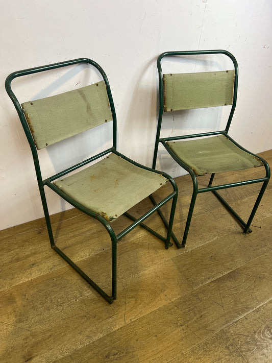 Pair of green metal stacking chairs