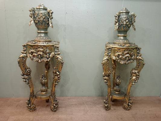 Pair of handcarved Rocco style gilt wood pedestals with carved urn finial tops on 3 scrolled cabriole legs richly adorned with floral motifs, acanthus leaf design
