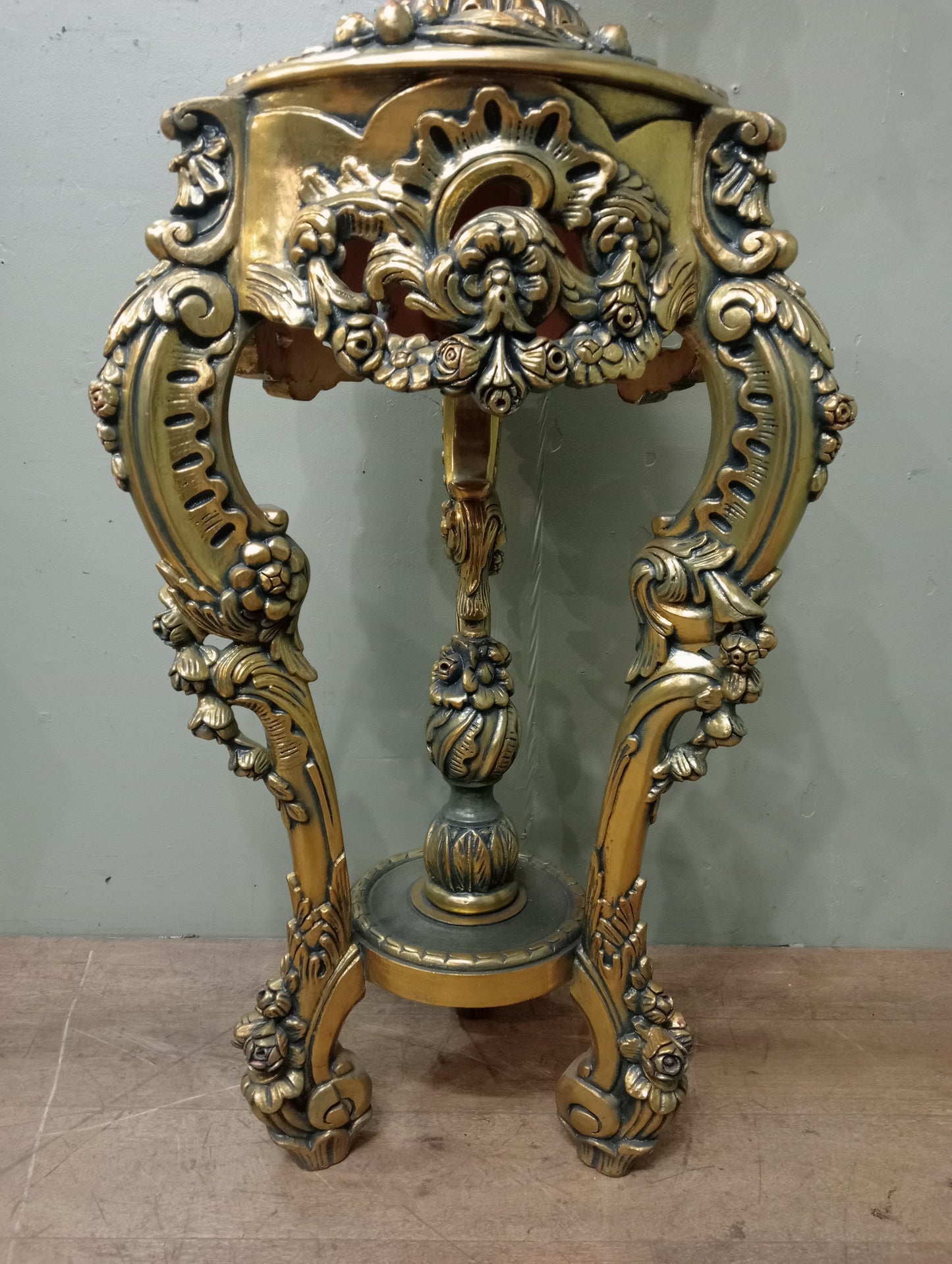 Pair of handcarved Rocco style gilt wood pedestals with carved urn finial tops on 3 scrolled cabriole legs richly adorned with floral motifs, acanthus leaf design