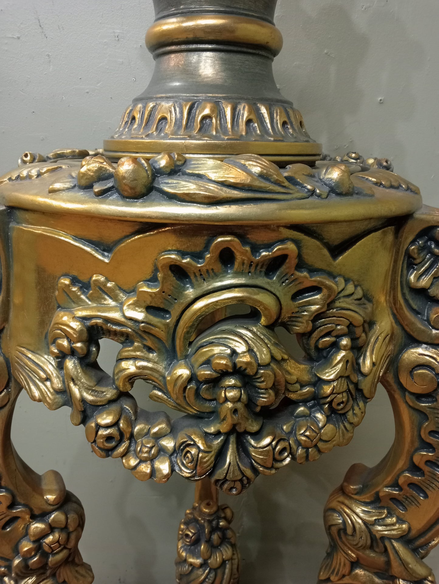 Pair of handcarved Rocco style gilt wood pedestals with carved urn finial tops on 3 scrolled cabriole legs richly adorned with floral motifs, acanthus leaf design