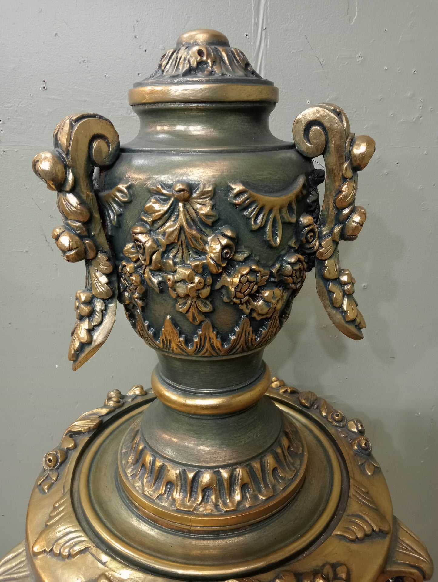 Pair of handcarved Rocco style gilt wood pedestals with carved urn finial tops on 3 scrolled cabriole legs richly adorned with floral motifs, acanthus leaf design