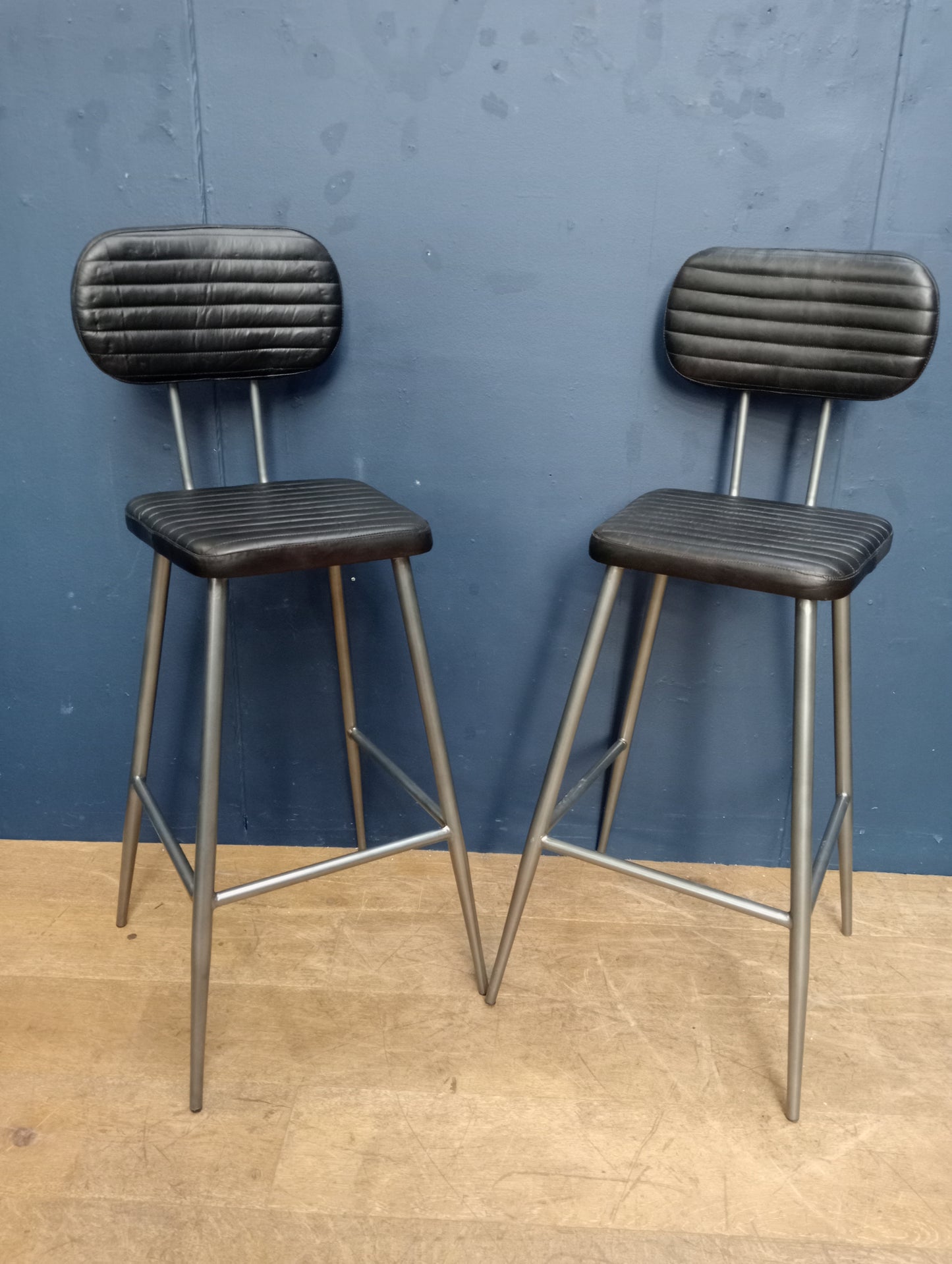 Pair of metal black ribbed seat and back high stools