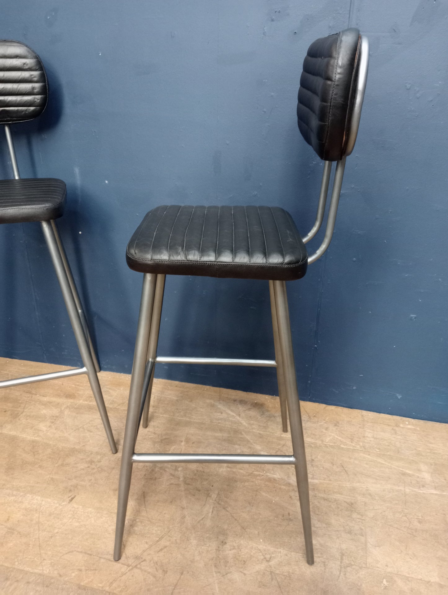 Pair of metal black ribbed seat and back high stools