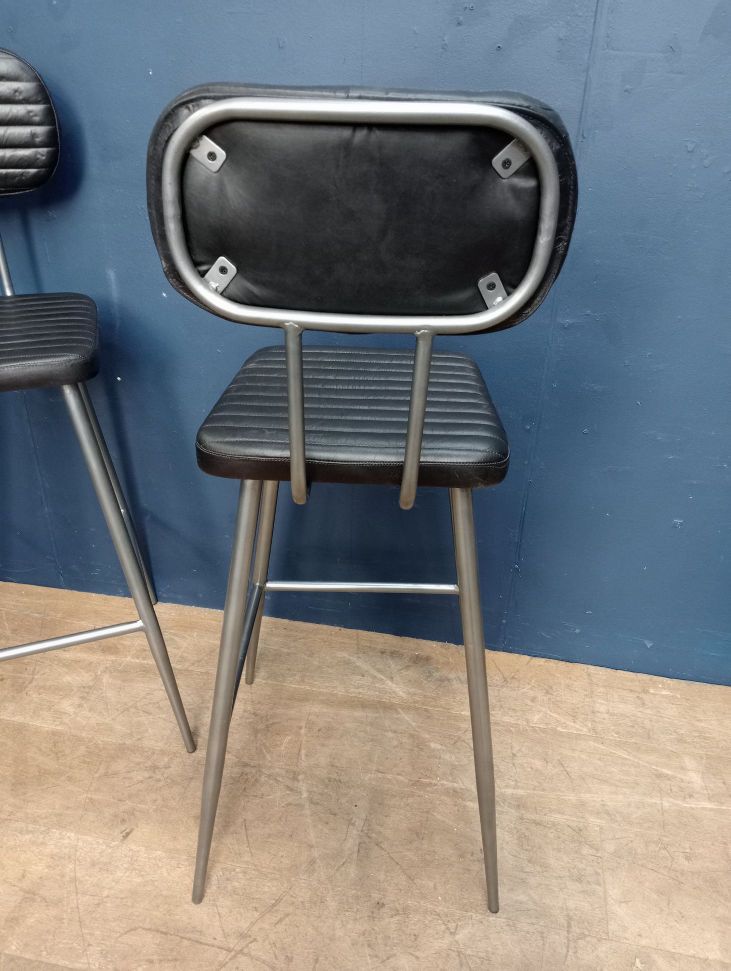 Pair of metal black ribbed seat and back high stools