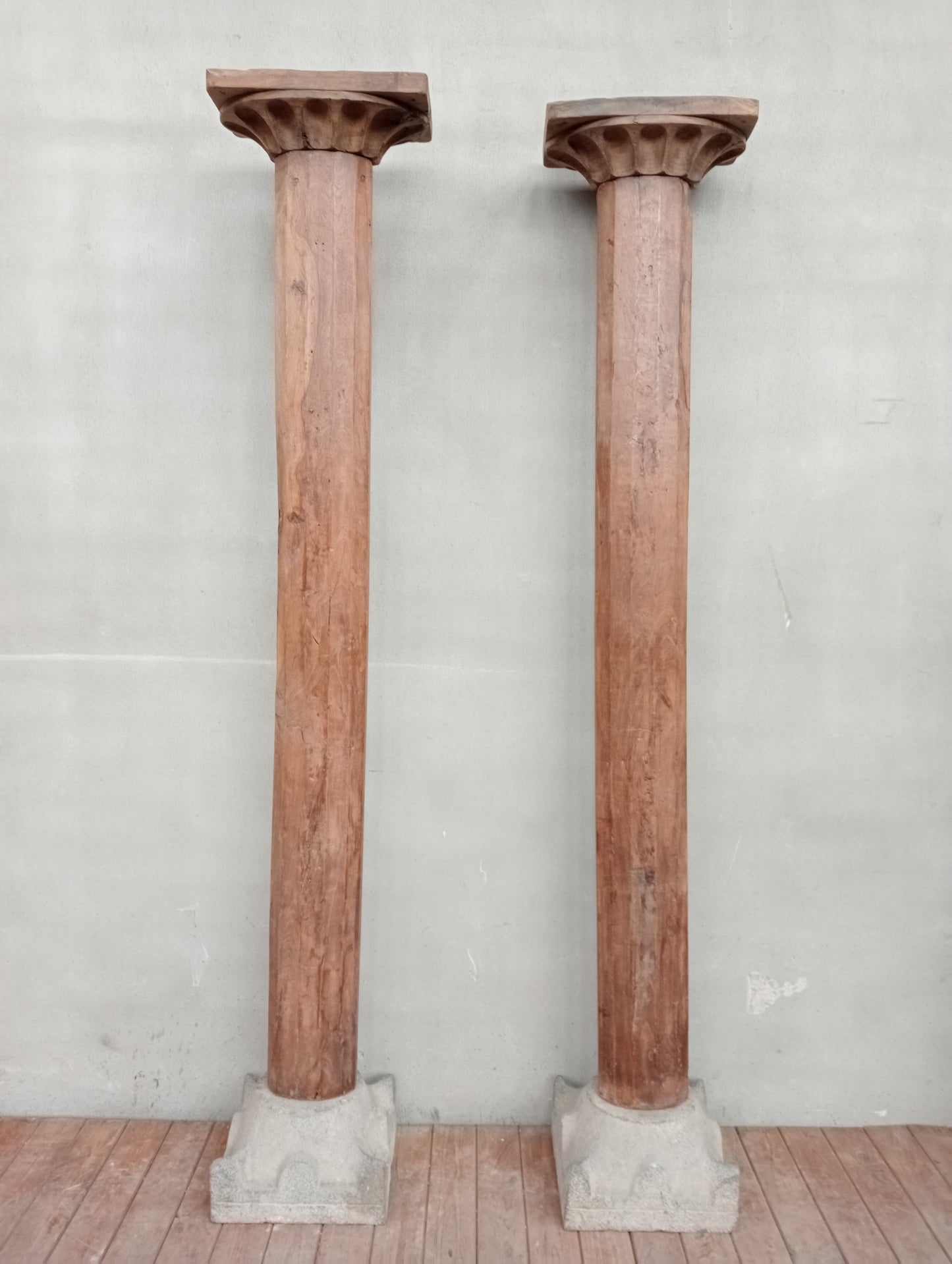 Pair of wooden columns with stone base