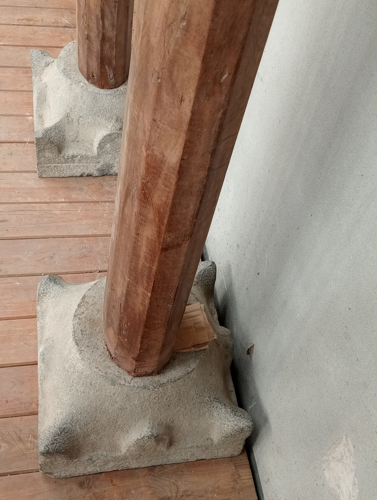 Pair of wooden columns with stone base