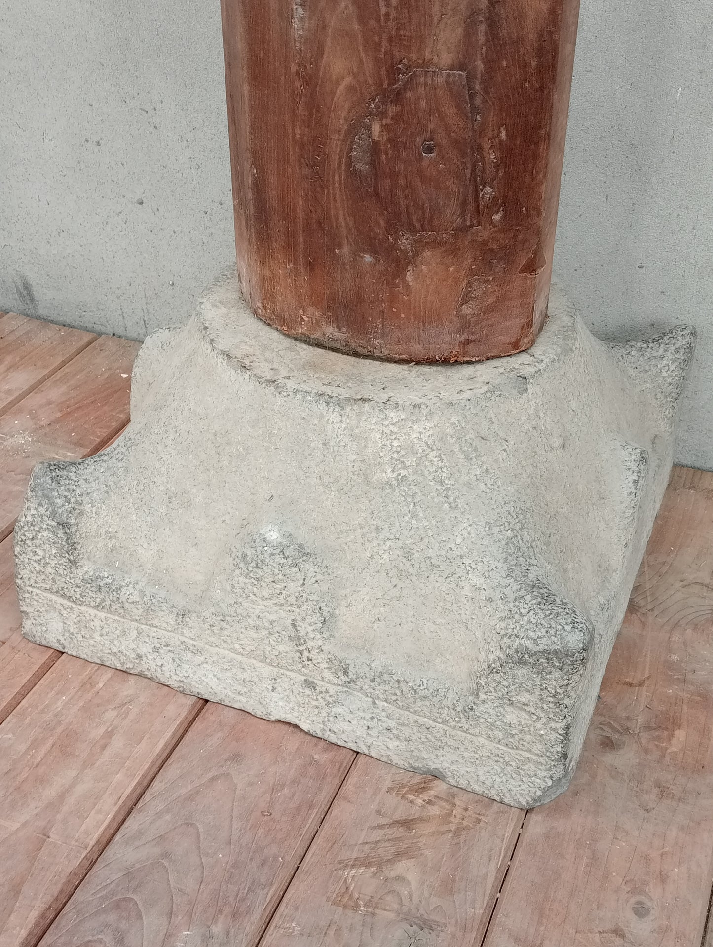 Pair of wooden columns with stone base