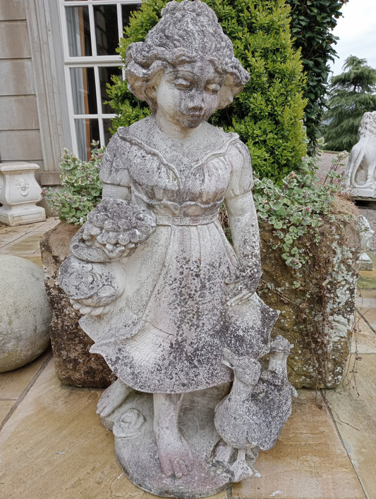 Stone girl figure with ducks