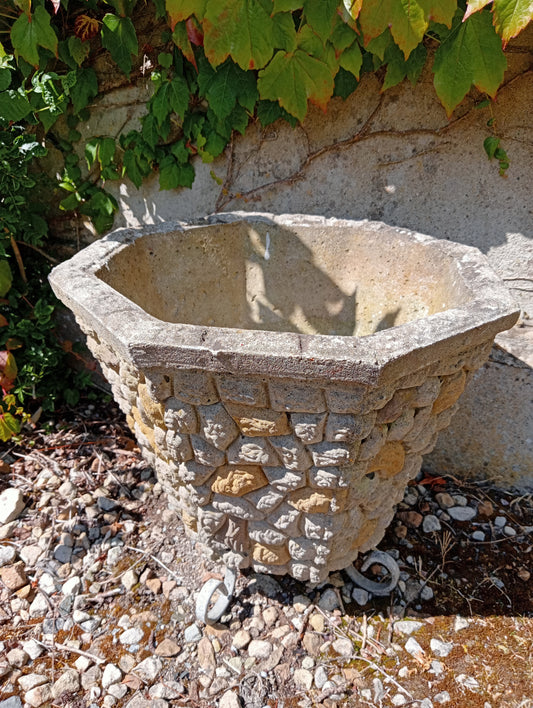Stone planter with wrought iron legs