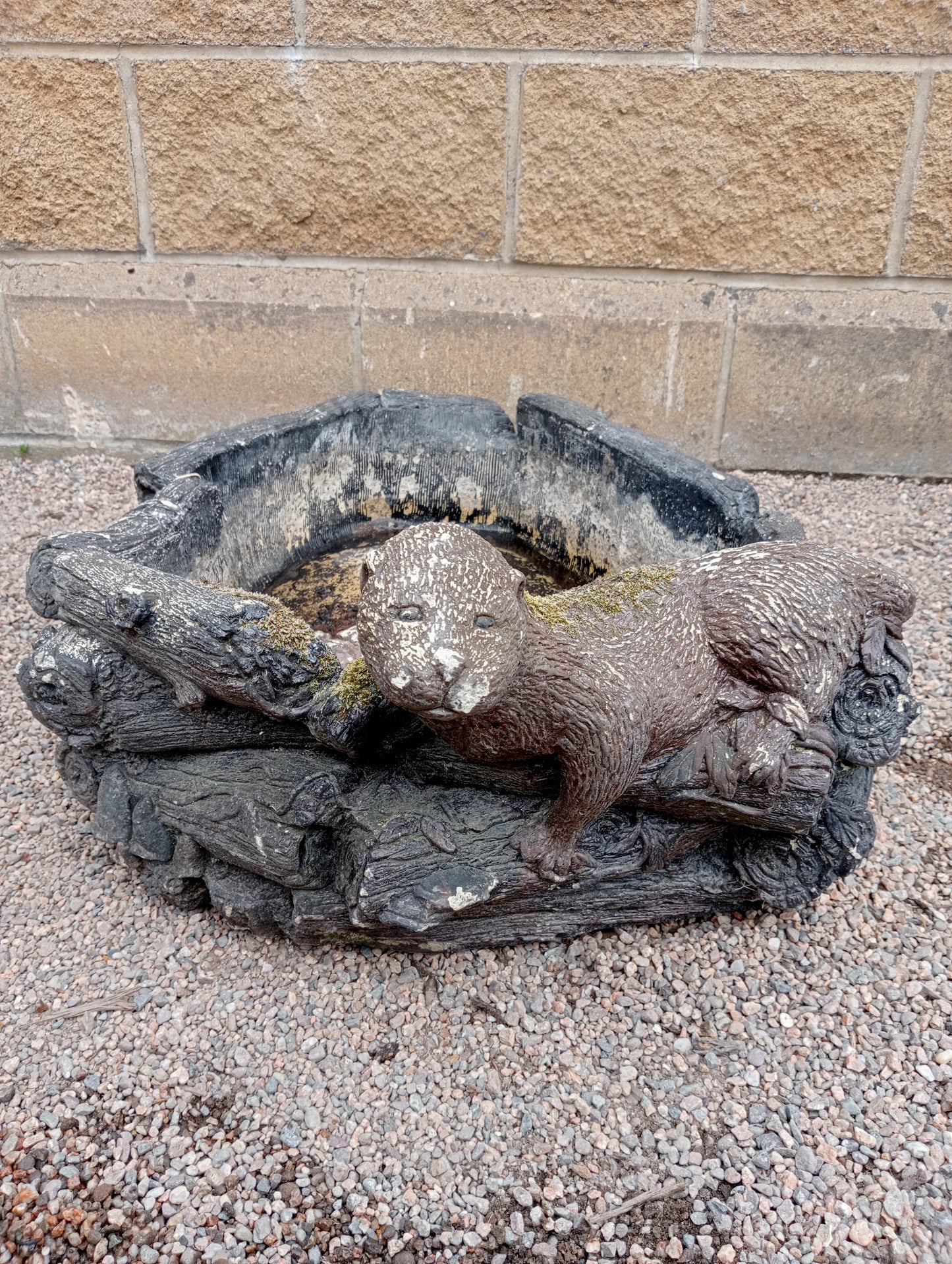 Stone water feature with one otter