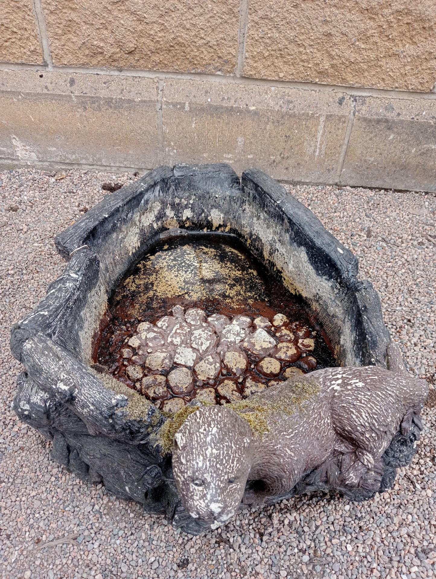 Stone water feature with one otter