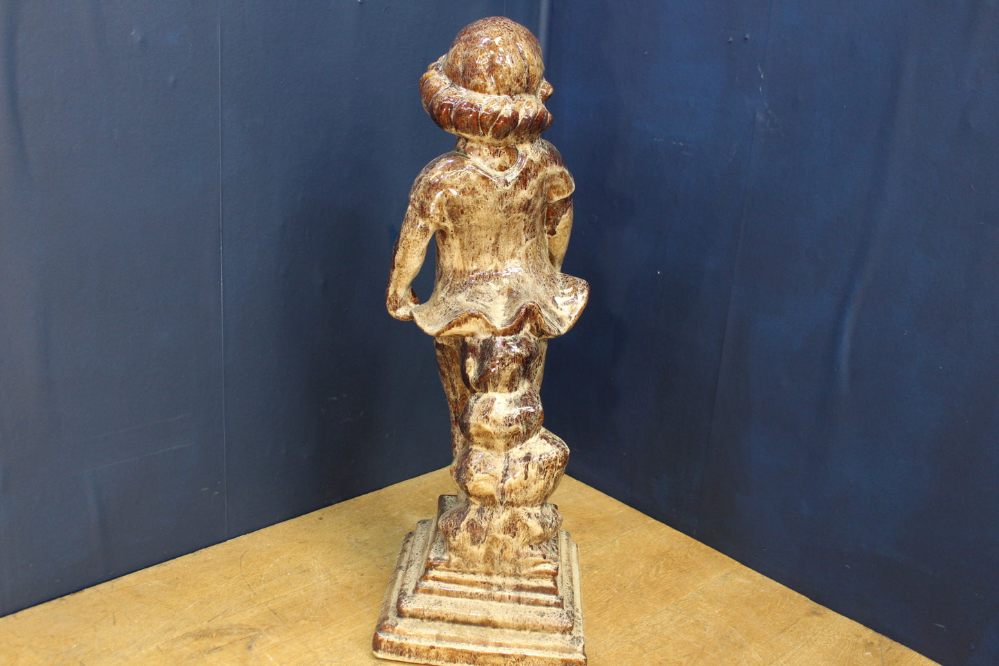 Terracotta glazed girl holding dress