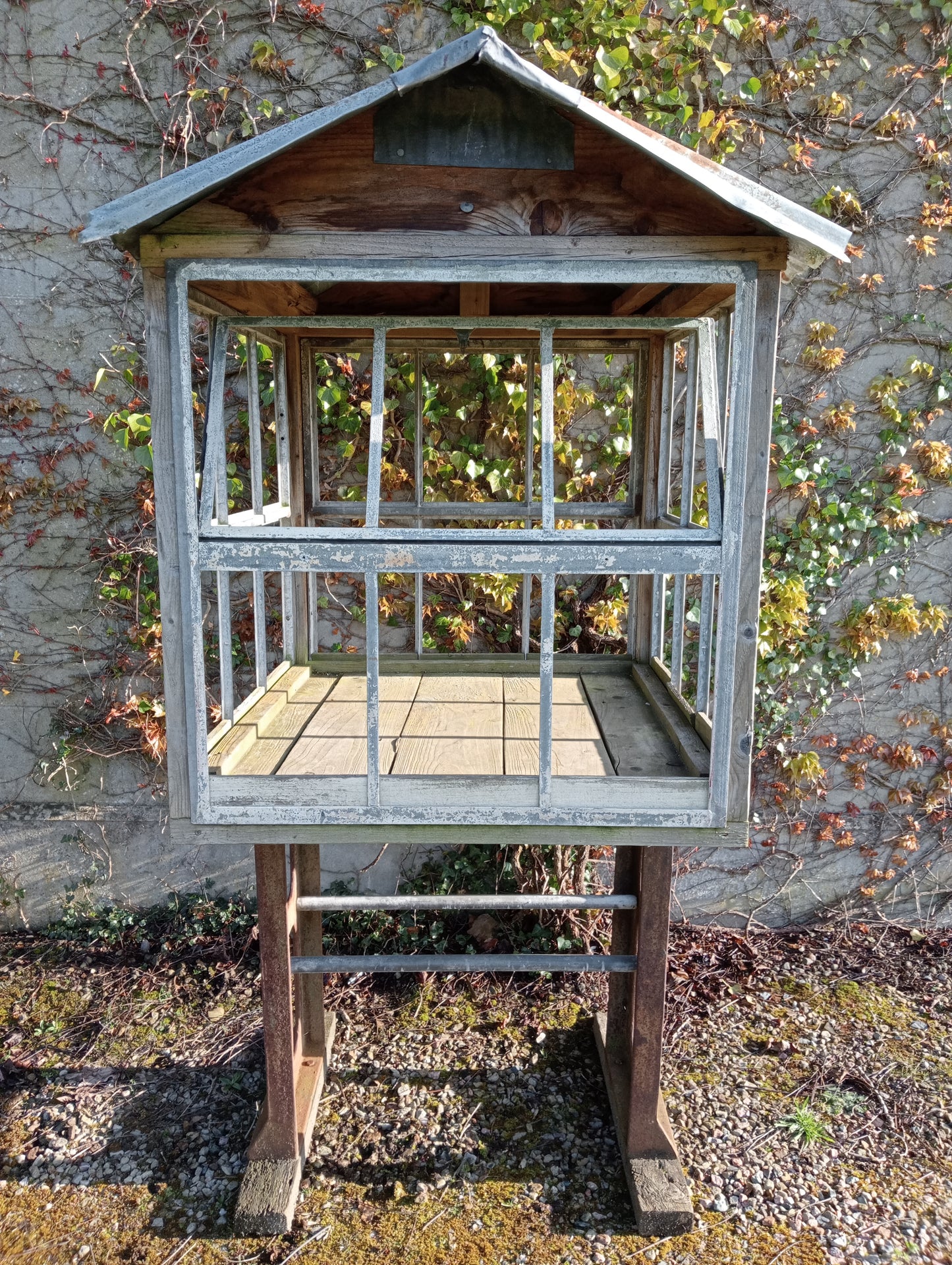 Victorian style greenhouse on cast iron machine base