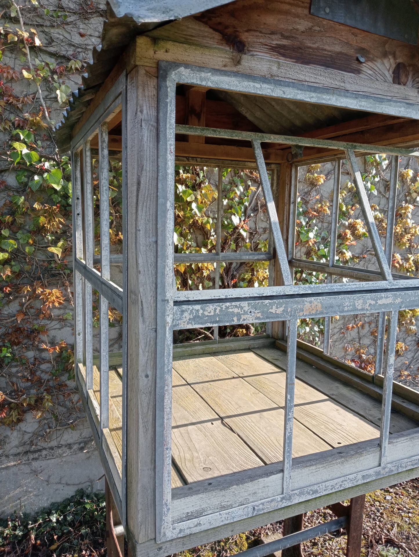 Victorian style greenhouse on cast iron machine base