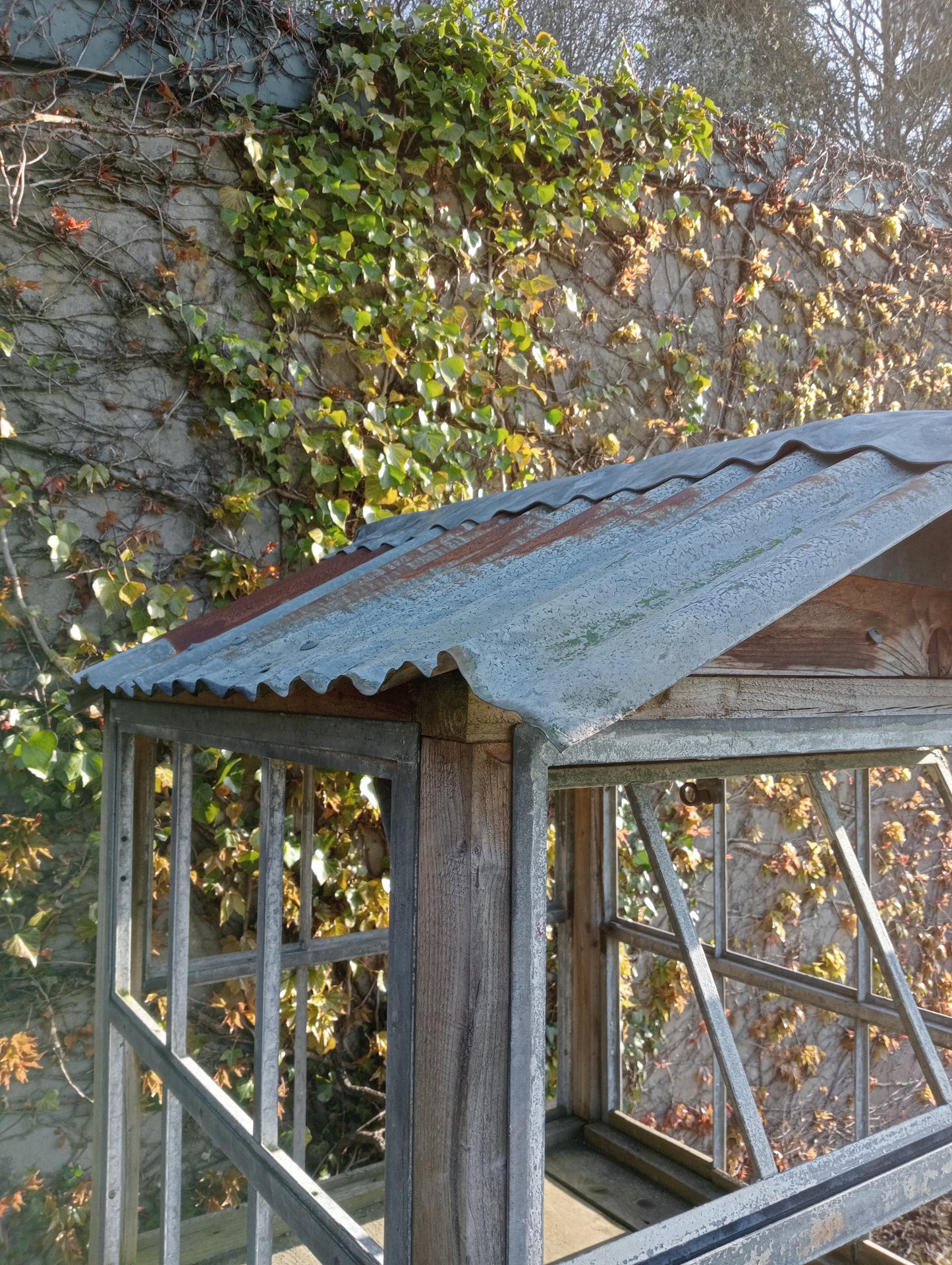 Victorian style greenhouse on cast iron machine base