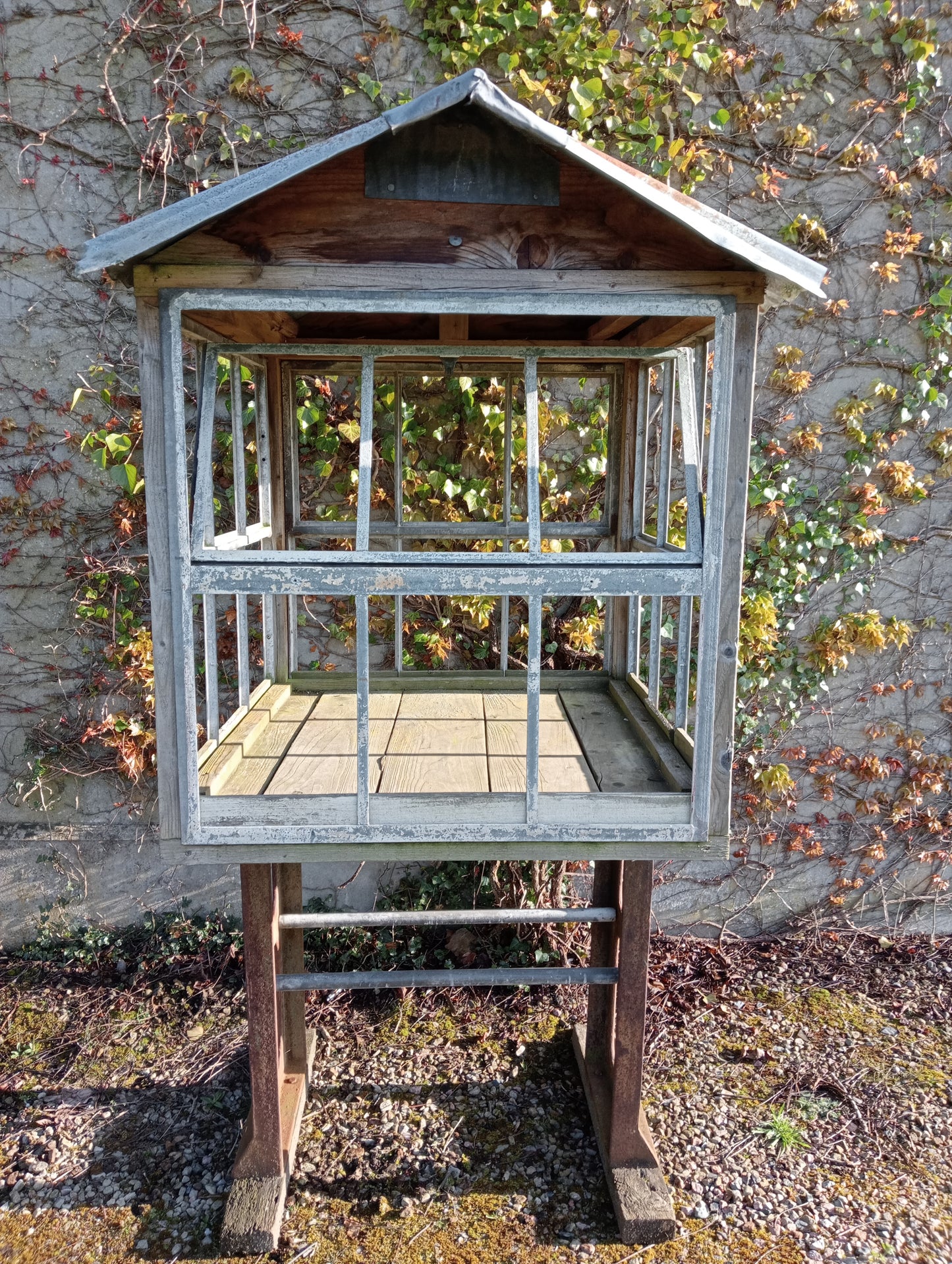 Victorian style greenhouse on cast iron machine base