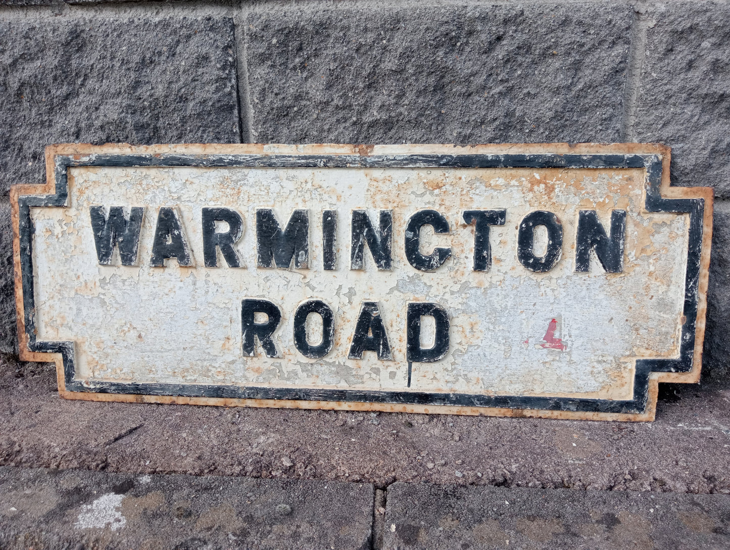 Warmington road cast iron street sign